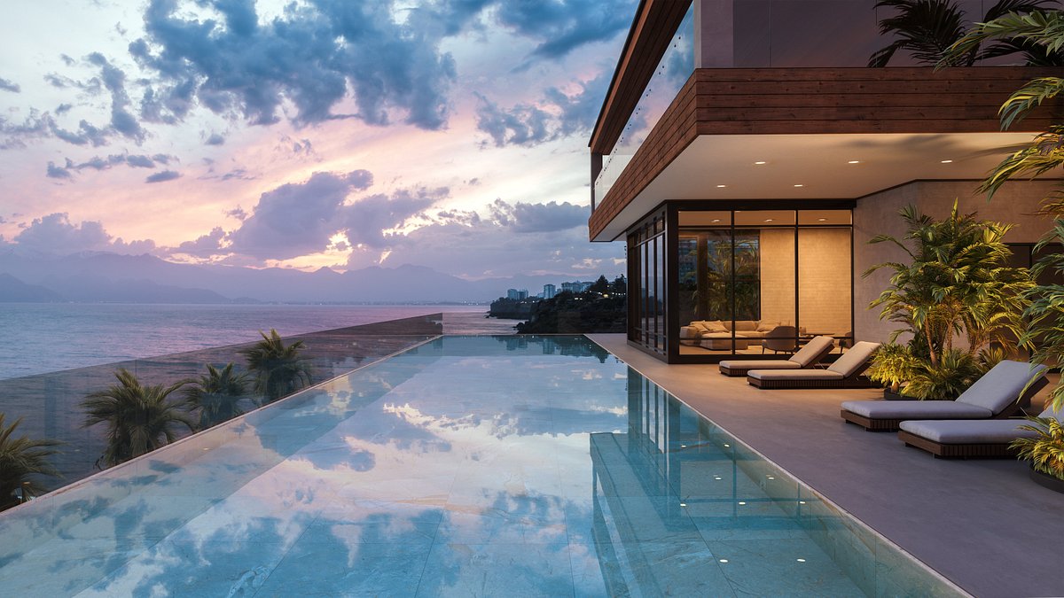 Villa moderne de luxe avec piscine à débordement donnant sur l'océan au coucher du soleil.